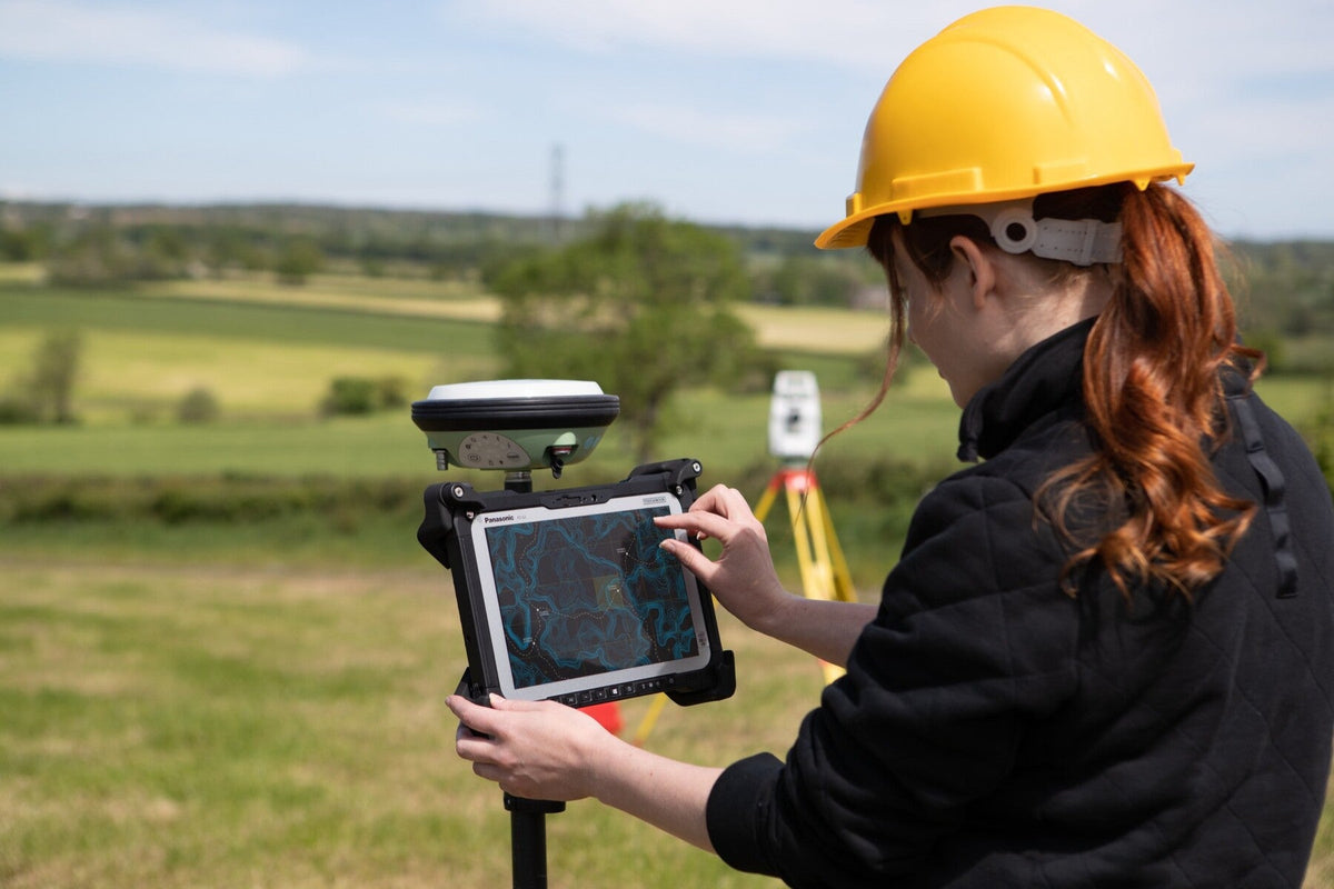 Surveyor using the Panasonic TOUGHBOOK G2 mk2 (5G, EU plug) on a GNSS pole for field mapping and GIS data capture